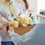 Image of elderly being handed a bag of groceries representing food pantries in Tampa